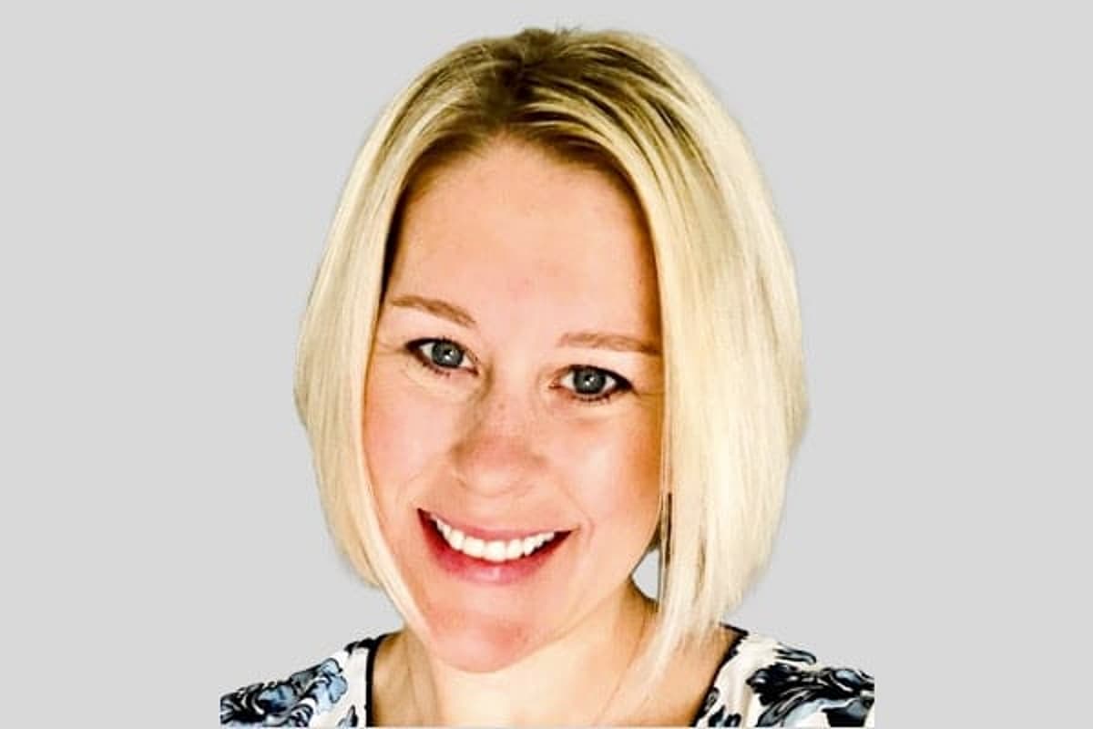 Woman with short blond hair smiling