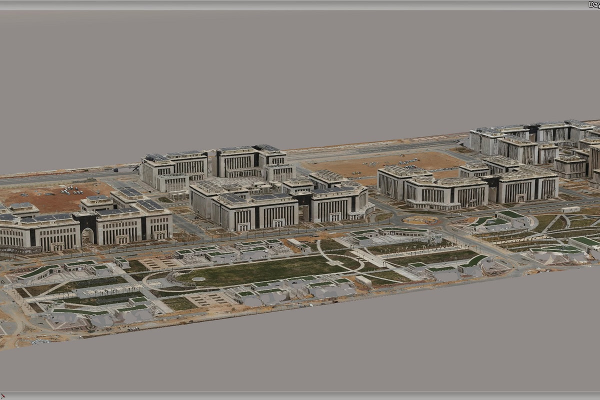 Aerial 3D rendering of a sprawling modern campus with clustered buildings, landscaped courtyards, roads, and parking areas in a muted setting.