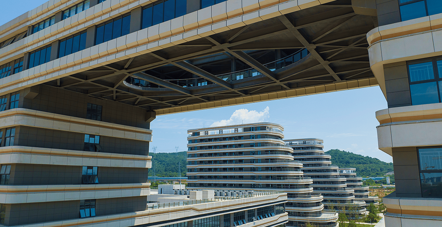An eye-level view of a modern office complex connected by an elevated sky-bridge, highlighting innovative architectural engineering, collaborative spaces, and sustainable commercial design.