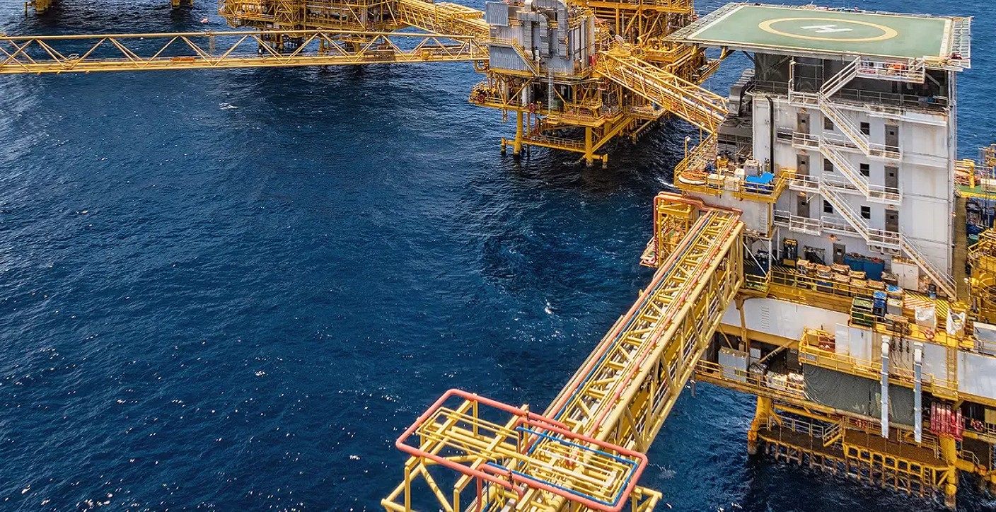 View of connected offshore oil and gas production platforms in the deep blue ocean, highlighting complex multidisciplinary engineering and global energy supply infrastructure.