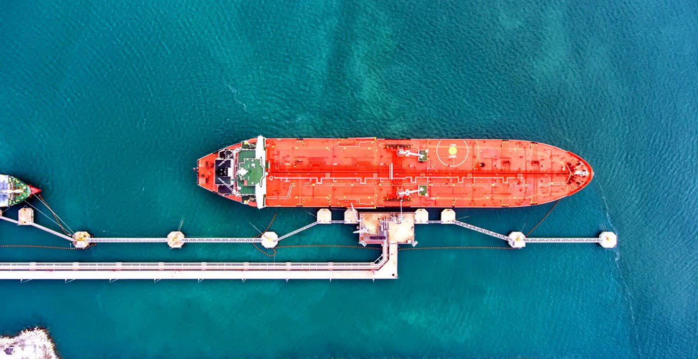 View of a bustling container terminal with cargo ships docked at berths and gantry cranes in operation, showcasing global trade via ports and waterways, marine supply chains, and efficient logistics infrastructure.