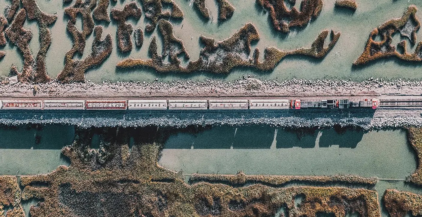 An aerial view of simultaneous working road and rail systems.
