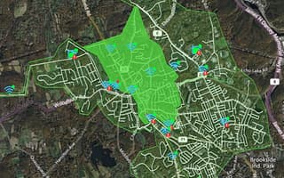 OpenFlows WaterSight map showing a water network with real-time sensor data and alerts in a highlighted zone