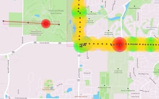 A screenshot of the PLS-Grid software displaying a heat map of a power line on a geographical map. The heat map uses green, yellow, and red to show the status of the line as it passes over streets and parks.