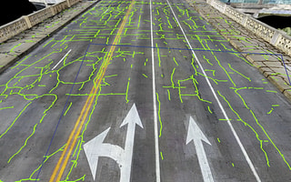 AI-powered crack detection on a 3D reality model of a road processed by iTwin Capture Cloud Services.