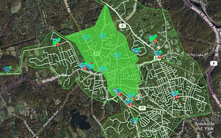 OpenFlows WaterSight map showing a water network with real-time sensor data and alerts in a highlighted zone