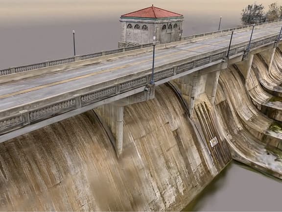 High-resolution 3D reality mesh of a concrete dam and bridge deck generated by iTwin Capture Cloud Services, illustrating precise structural documentation and asset capture.