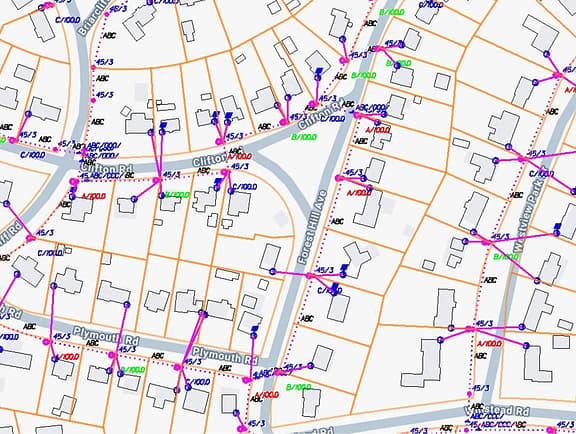 GIS-based utility network map in OpenUtilities Map, showing residential lot boundaries, pink distribution lines, labeled utility poles, and municipal street alignments.