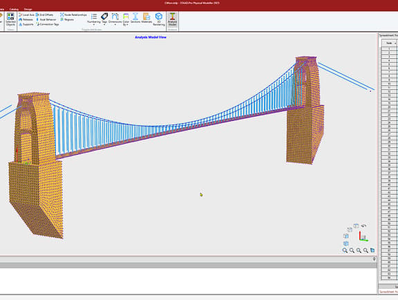 An analysis model view of a suspension bridge in STAAD.Pro, showing a detailed finite element mesh