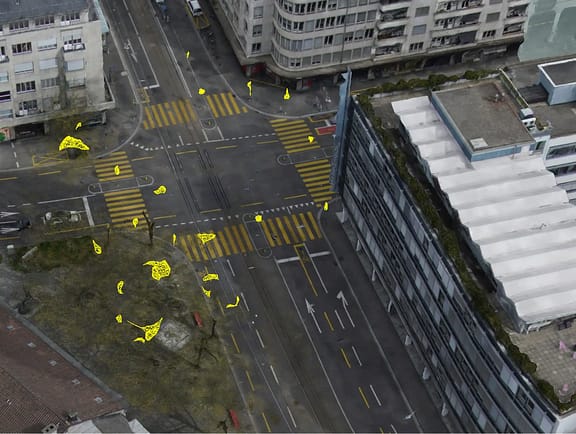 Aerial reality mesh of an urban street intersection in iTwin Capture Modeler, featuring yellow vector overlays for municipal object detection and spatial asset marking.