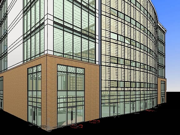 Detailed architectural 3D building model in OpenBuildings Designer, showing a modern glass curtain wall facade, structural framing, and a brick base corner.