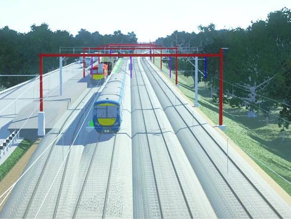 High-speed rail design model in OpenRail Designer, showcasing dual railway tracks, red overhead gantries, and a blue passenger train in a digital corridor landscape.