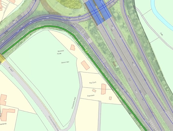 Roadway network map rendered in AssetWise Linear Network Management, showing a highway junction with a highlighted green route segment next to local streets, illustrating linear asset tracking and corridor visualization.