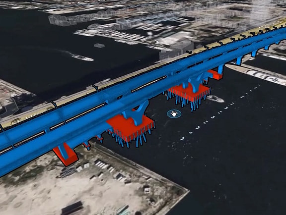 Carbon Analysis 3D bridge engineering model visualizing bridge structural components in blue and red over a GIS terrain map for environmental assessment.