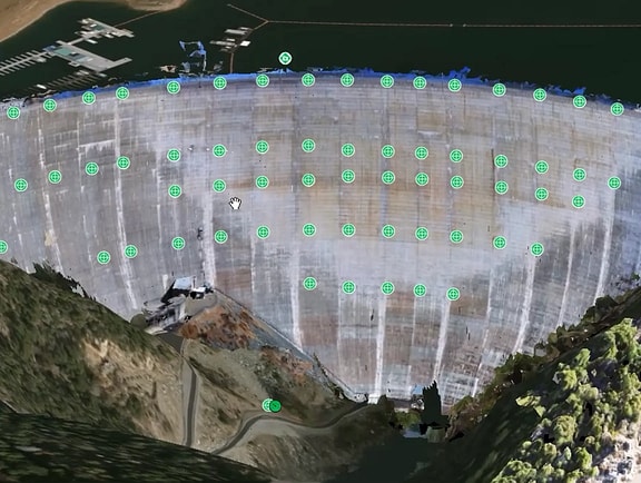 Geotechnical monitoring sensor layout on a large concrete dam wall in iTwin IoT, showing active sensor targets for structural health and real-time safety tracking.
