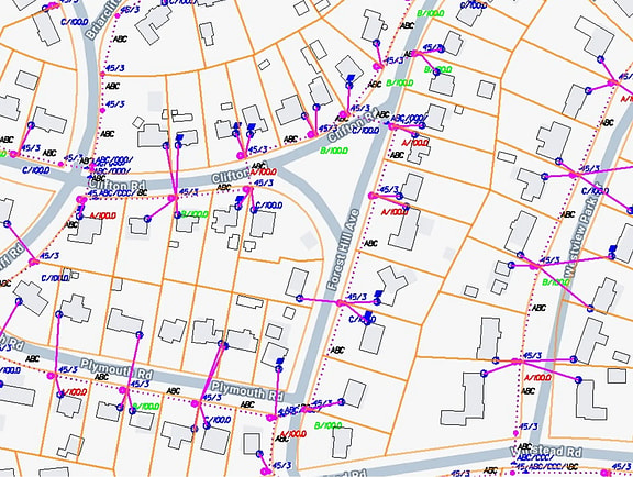 GIS-based utility network map in OpenUtilities Map, showing residential lot boundaries, pink distribution lines, labeled utility poles, and municipal street alignments.