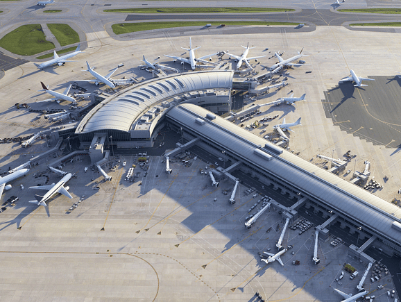 An aerial perspective of a modern, curved airport terminal with commercial airplanes at the gates, highlighting advanced aviation infrastructure, seamless air transit, and global passenger connectivity.