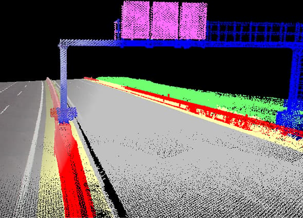 A classified point cloud of a highway in iTwin Capture WorkSuite, with assets like signs and guardrails highlighted in different colors.