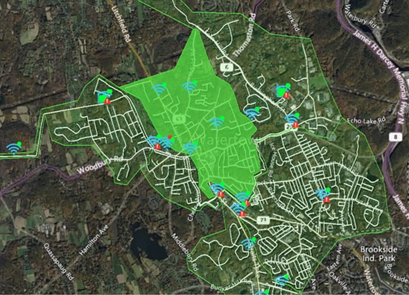 OpenFlows WaterSight map showing a water network with real-time sensor data and alerts in a highlighted zone