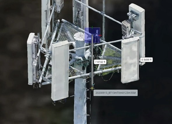 A high-resolution 3D digital twin scan of a telecommunications tower head in OpenTower iQ, showing white panel antennas labeled with physical dimensions.