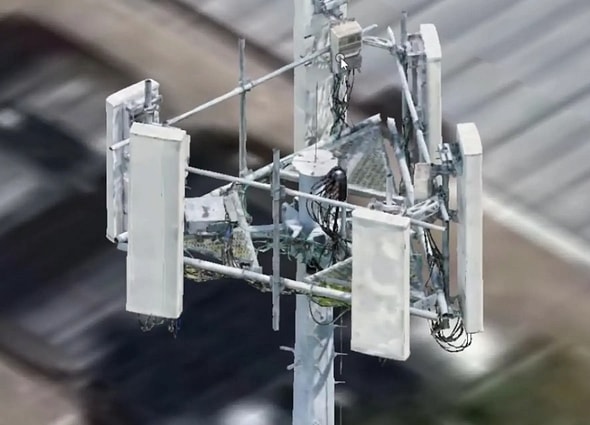 A close-up 3D model of a telecommunications tower head in OpenTower Mount Analysis, illustrating complex brackets, cabling, and white panel antennas.