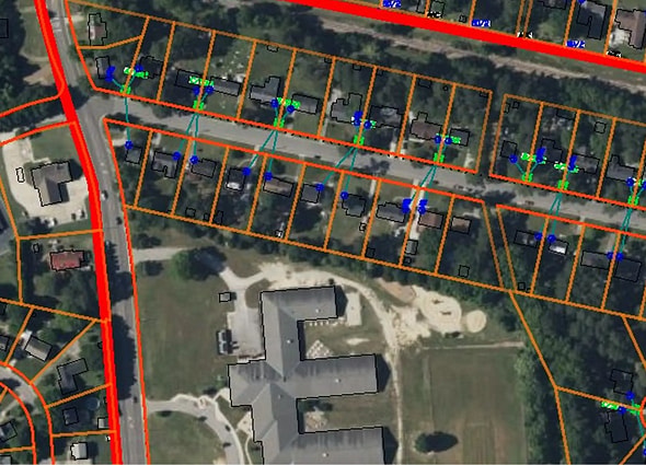 Utility network design and asset management within a residential area shown in OpenUtilities Designer.
