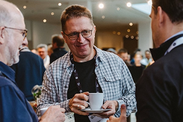 3 men interacting at networking event