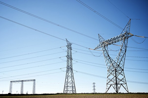 Power lines with blue sky as backdrop