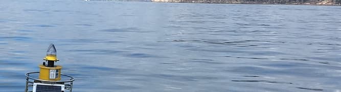 A solar-powered water quality monitoring buoy floating in the sea, one of 16 deployed by the Port of Townsville to provide real-time data for their Channel Upgrade project.