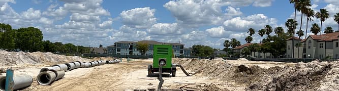 The 25-acre construction site for the Mevers School of Excellence in Florida, showing the sandy soil and initial earthworks for the large underground stormwater system.