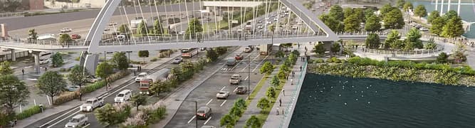 Rendering of a large arch bridge over a highway, connecting green park spaces in an urban setting