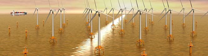A heavy-lift vessel installing large foundations for an offshore wind farm in the open sea