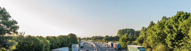 A busy motorway in the UK, representing the strategic road network that Highways England manages through its connected data environment.