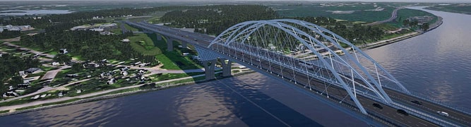 Large steel arch bridge spans a wide river, connecting two areas of green landscape under a partly cloudy sky. Vehicles are visible traveling across the bridge.