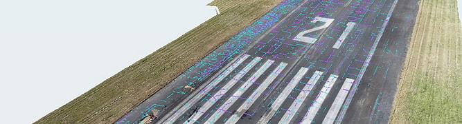 A digital twin of an airport runway, showing AI-detected cracks automatically highlighted on the pavement surface as part of Benesch's pavement management program for the Chicago Department of Aviation. 