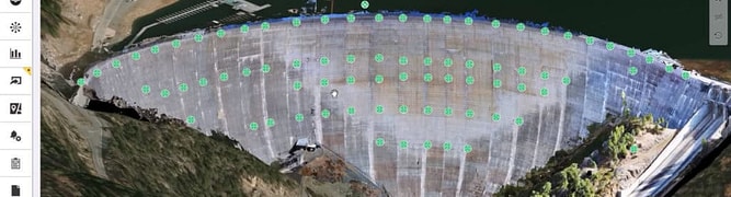 A screenshot of the iTwin IoT platform displaying a 3D digital twin of the New Bullards Bar Dam, with green dots indicating the locations of 83 real-time monitoring sensors.