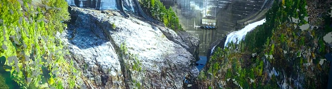 A detailed digital twin of the Diablo Dam, showing the concrete arch structure nestled in its steep, forested canyon, as captured through drone photogrammetry.