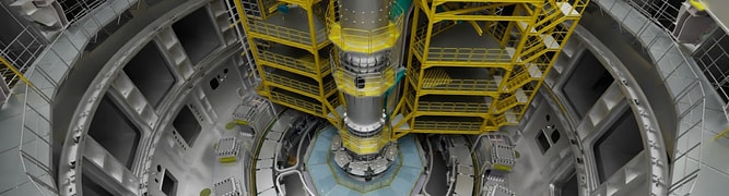 Inside view of the ITER (International Thermonuclear Experimental Reactor) assembly hall, showing complex machinery and yellow scaffolding structures for tokamak construction.