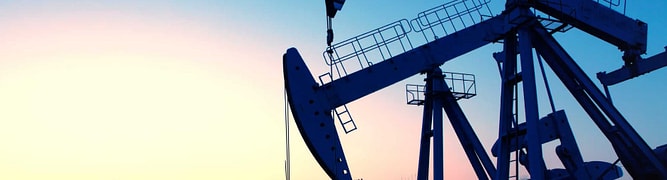 Multiple oil pumpjacks operating in an onshore field at sunset, representing the oil and gas industry where Seequent's software helps teams visualize subsurface geology.