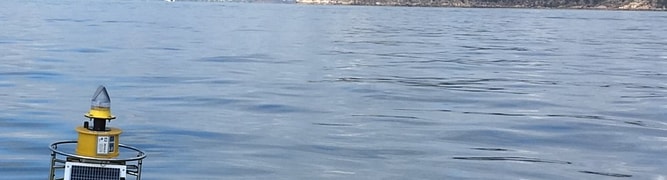 A solar-powered water quality monitoring buoy floating in the sea, one of 16 deployed by the Port of Townsville to provide real-time data for their Channel Upgrade project.