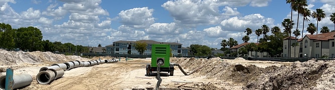 The 25-acre construction site for the Mevers School of Excellence in Florida, showing the sandy soil and initial earthworks for the large underground stormwater system.