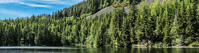 View of a large reservoir and a rockfill slope, representing the type of environment where 3D numerical analysis was conducted using GeoStudio to assess groundwater seepage and stability for a large dam.