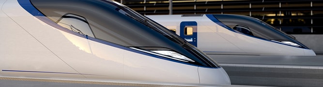  Two HS2 high-speed trains at a platform, the visible outcome of a massive infrastructure project where Mott MacDonald used Leapfrog Works to manage complex earthworks and material reuse.