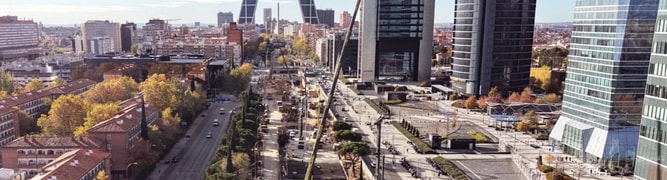 An aerial view of the major urban redevelopment and underground infrastructure construction along Paseo de la Castellana in downtown Madrid, Spain.