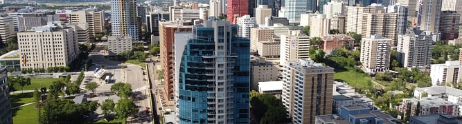 An aerial photograph of the downtown Edmonton skyline, the subject of a comprehensive, survey-grade 3D digital twin created by the City of Edmonton for urban planning and management.