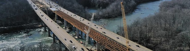 Aerial view of a large-scale interstate bridge construction project over a river 