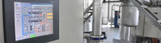 A view of an LLC Aqua water treatment plant, showing the digital control interface alongside the complex piping system that was designed and installed using a 3D digital workflow.