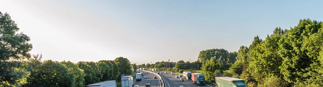 A busy motorway in the UK, representing the strategic road network that Highways England manages through its connected data environment.