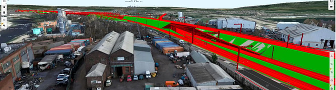 A screenshot of the Transpennine Route Upgrade's digital twin, showing a 3D design of the new railway alignment overlaid on a reality model of the existing urban and industrial environment.