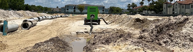 The 25-acre construction site for the Mevers School of Excellence in Florida, showing the sandy soil and initial earthworks for the large underground stormwater system.